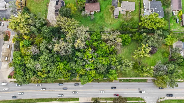 an aerial view of residential house with green space
