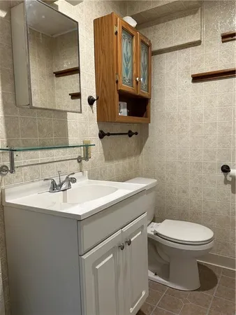 a bathroom with a toilet sink and mirror