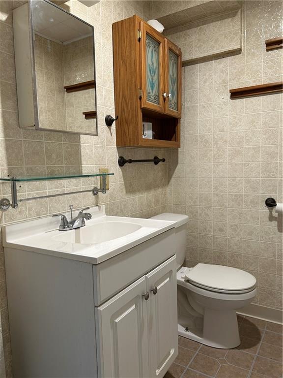 217 Arthur Street, Unit 1 Zelienople, PA 16063 - Photo 7 of 13 a bathroom with a toilet sink and mirror