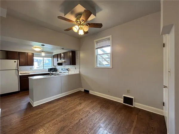 a view of a kitchen with a sink cabinets and wooden floor