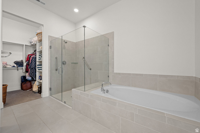 531 North Legend Way West, Unit D Mapleton, UT 84664 - Photo 18 of 42 Full bath featuring a walk in closet, a bath, a shower stall, light tile patterned flooring, and recessed lighting