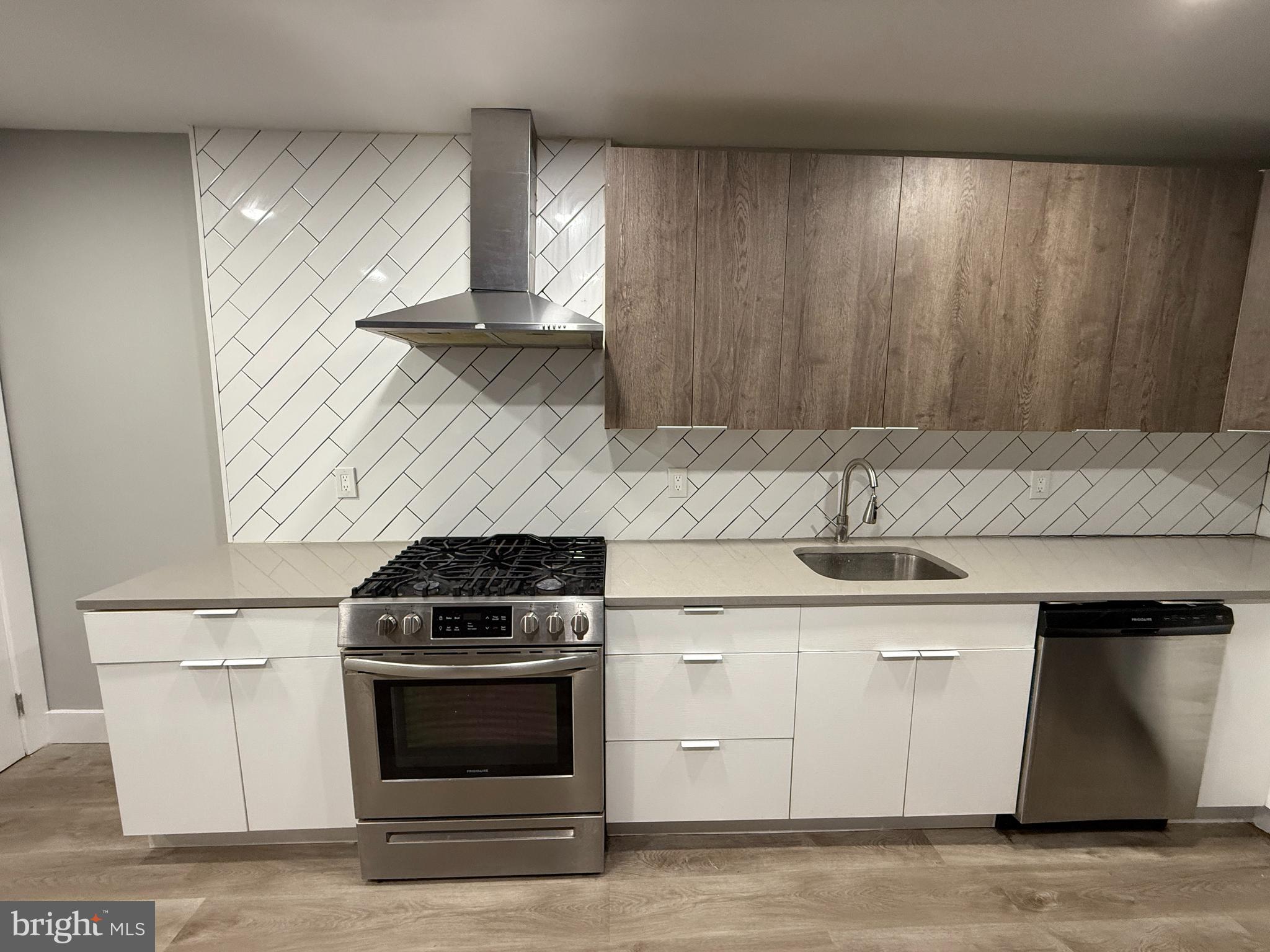 2943 Wharton Street Philadelphia, PA 19146 - Photo 13 of 36 a kitchen with granite countertop a stove and a sink