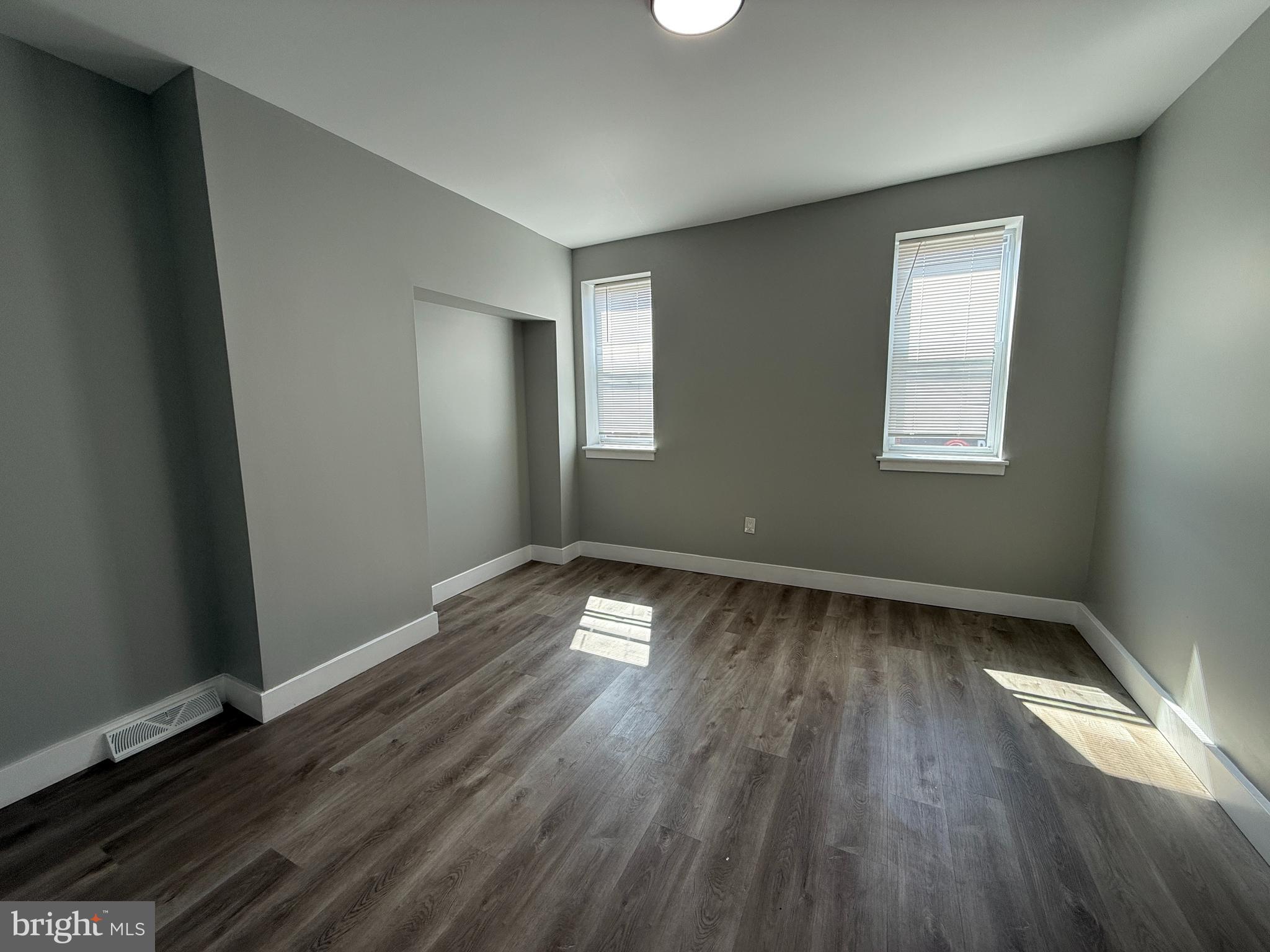 2943 Wharton Street Philadelphia, PA 19146 - Photo 22 of 36 an empty room with wooden floor and windows