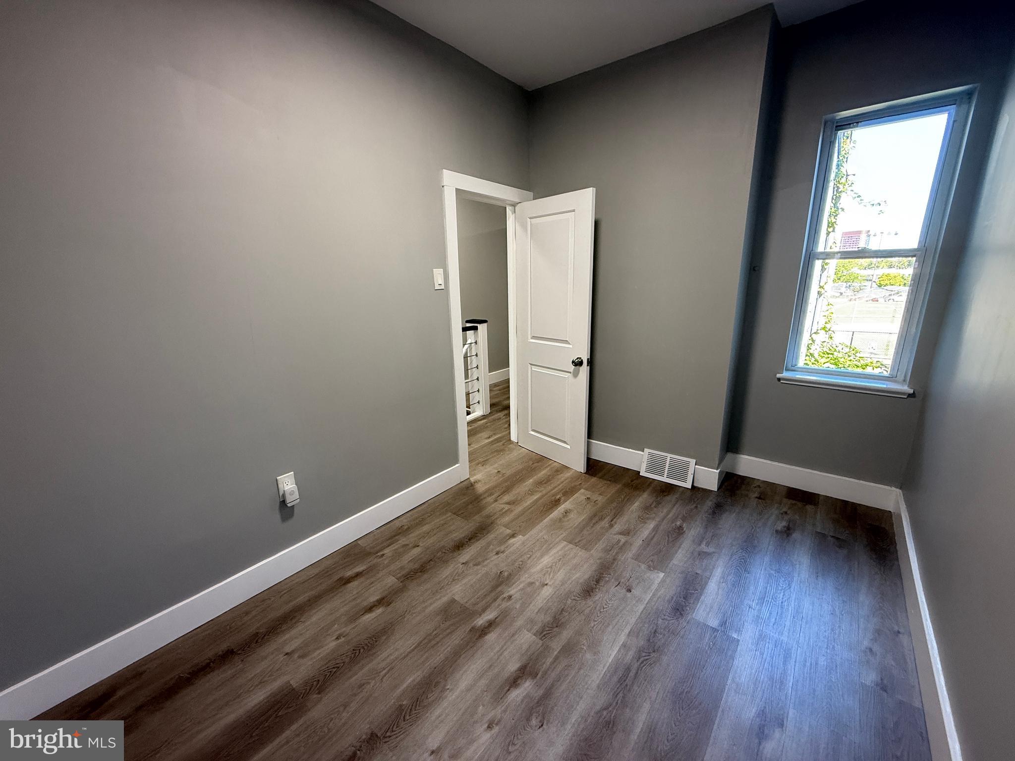 2943 Wharton Street Philadelphia, PA 19146 - Photo 26 of 36 an empty room with wooden floor and windows
