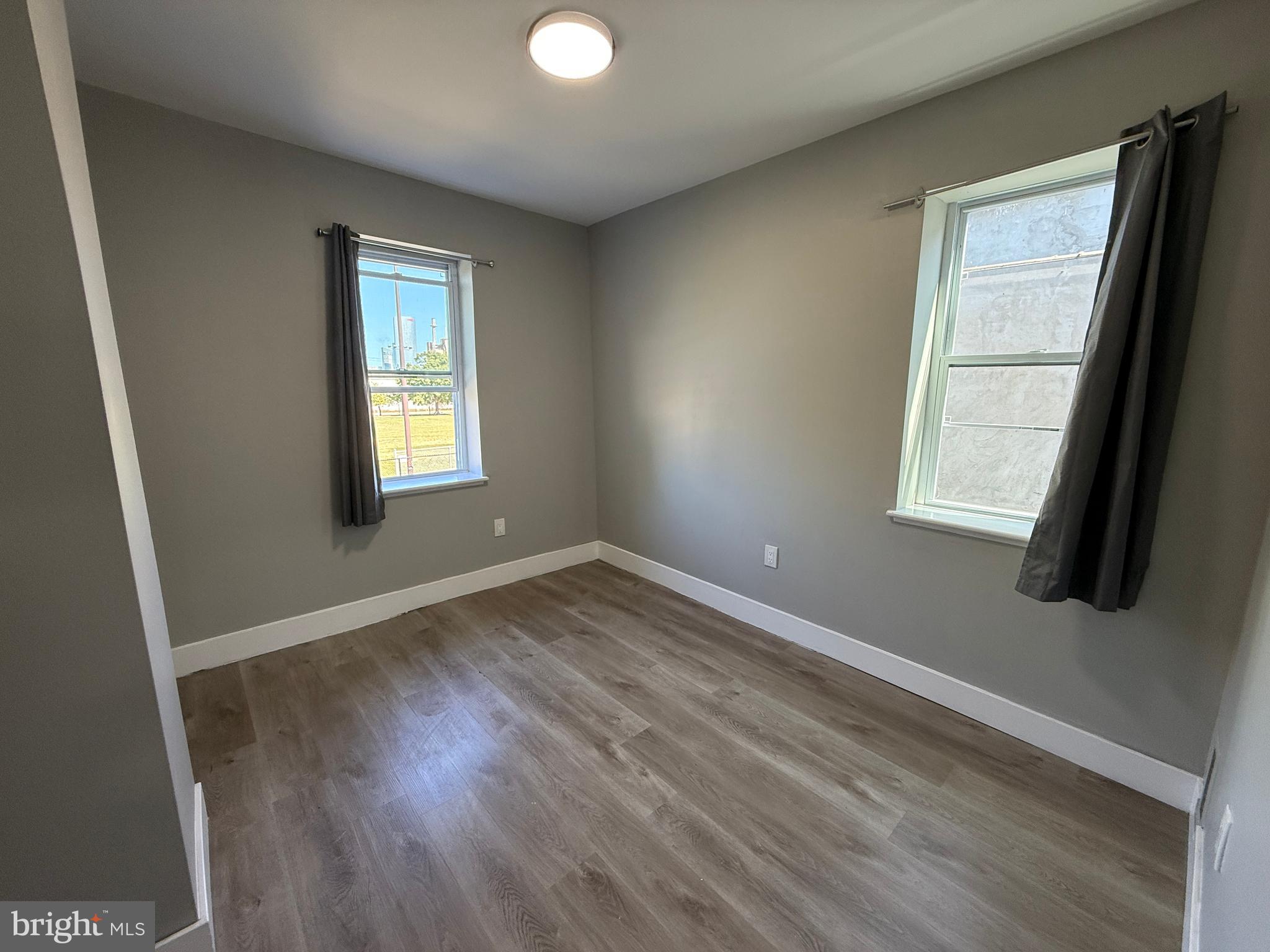 2943 Wharton Street Philadelphia, PA 19146 - Photo 27 of 36 a view of an empty room with wooden floor and a window