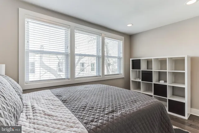 a large bed sitting in a bedroom next to a window