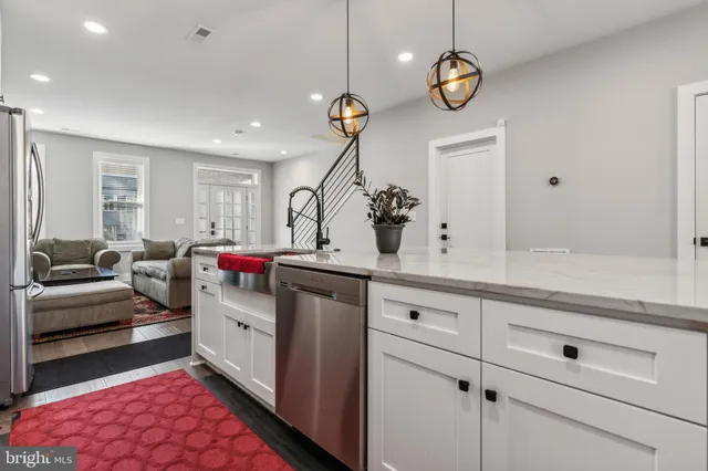 a living room with granite countertop furniture and a chandelier