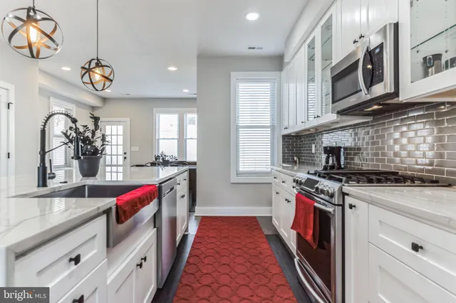 a kitchen with stainless steel appliances granite countertop a stove and a sink
