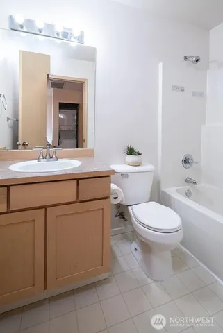 a bathroom with a toilet a sink and bathtub