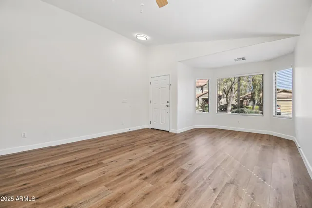 wooden floor in an empty room with a window