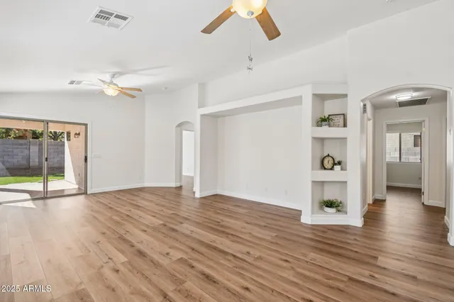 a kitchen with stainless steel appliances kitchen island wooden cabinets and wooden floors