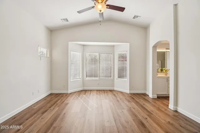 a view of kitchen with stove and wooden cabinets