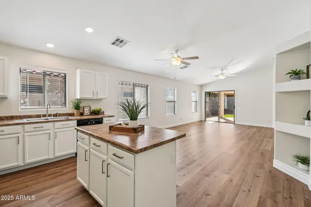 a kitchen with stainless steel appliances granite countertop a sink dishwasher stove top oven and refrigerator