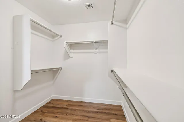 a bathroom with a tub a sink and mirror