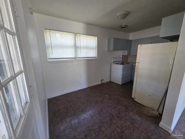 a view of a kitchen with a refrigerator and a window