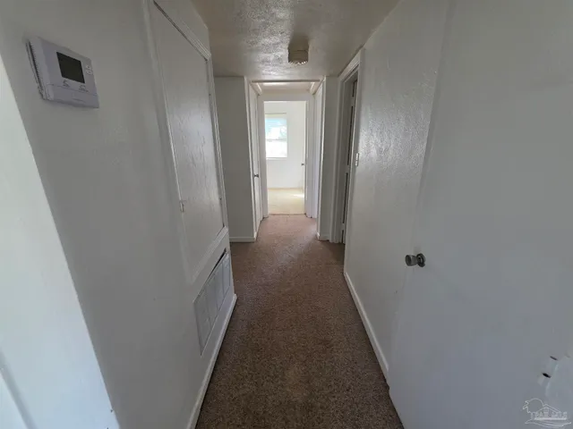 a view of a hallway with a wooden door