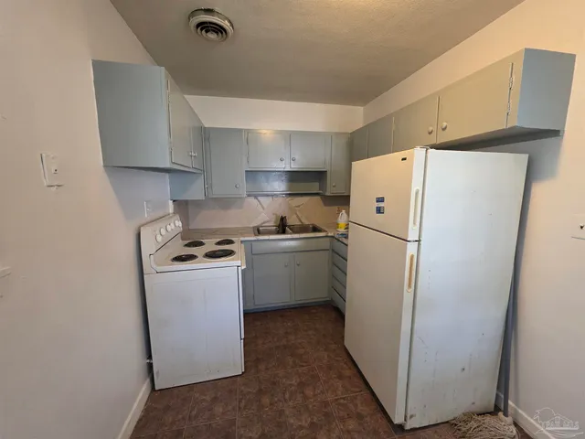a kitchen with a refrigerator a stove and a refrigerator