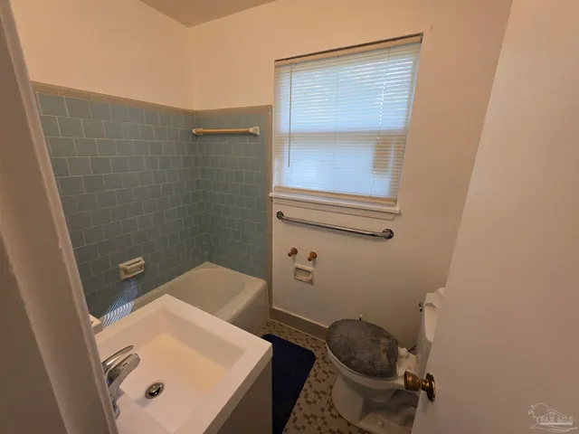 a bathroom with a toilet and a sink