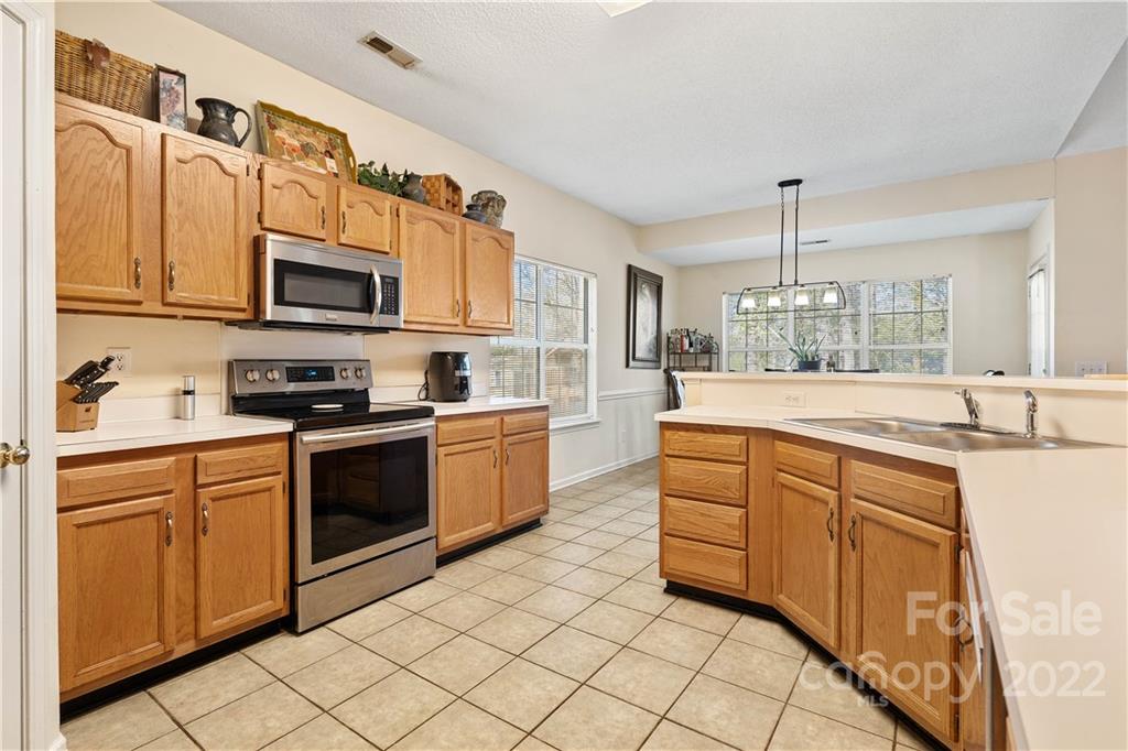 7001 Reedy Creek Road Charlotte, NC 28215 - Photo 12 of 24 a kitchen with stainless steel appliances granite countertop a sink and cabinets