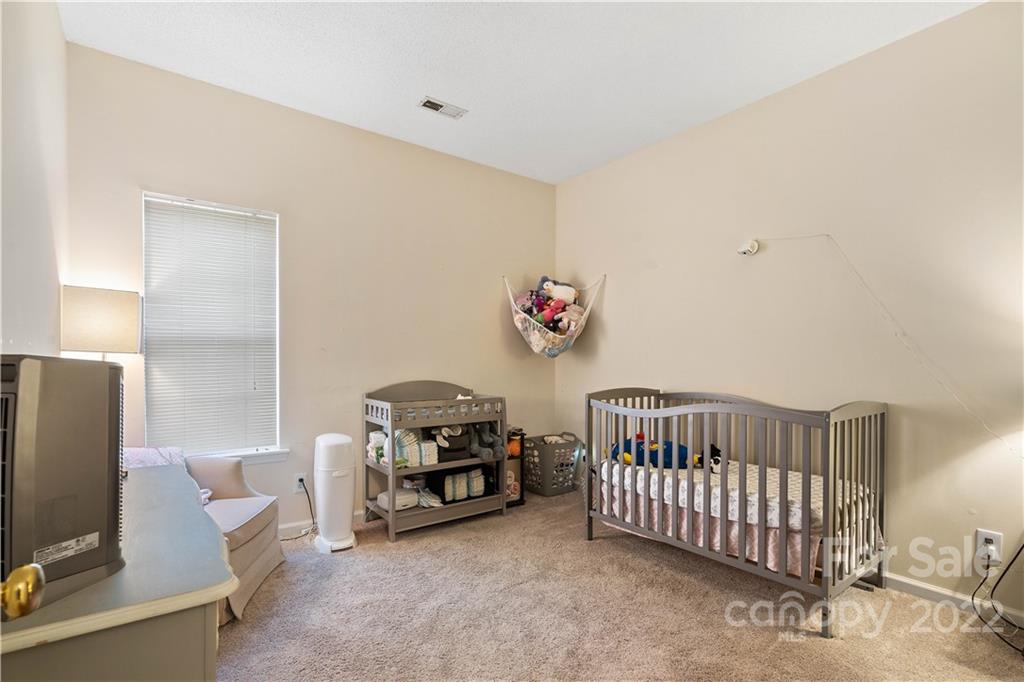 7001 Reedy Creek Road Charlotte, NC 28215 - Photo 14 of 24 a bedroom with furniture and a window