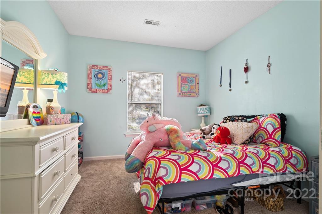 7001 Reedy Creek Road Charlotte, NC 28215 - Photo 15 of 24 a bedroom with two beds and a window