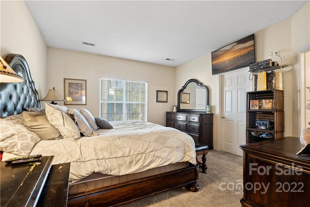 7001 Reedy Creek Road Charlotte, NC 28215 - Photo 17 of 24 a bedroom with a bed dresser and a window
