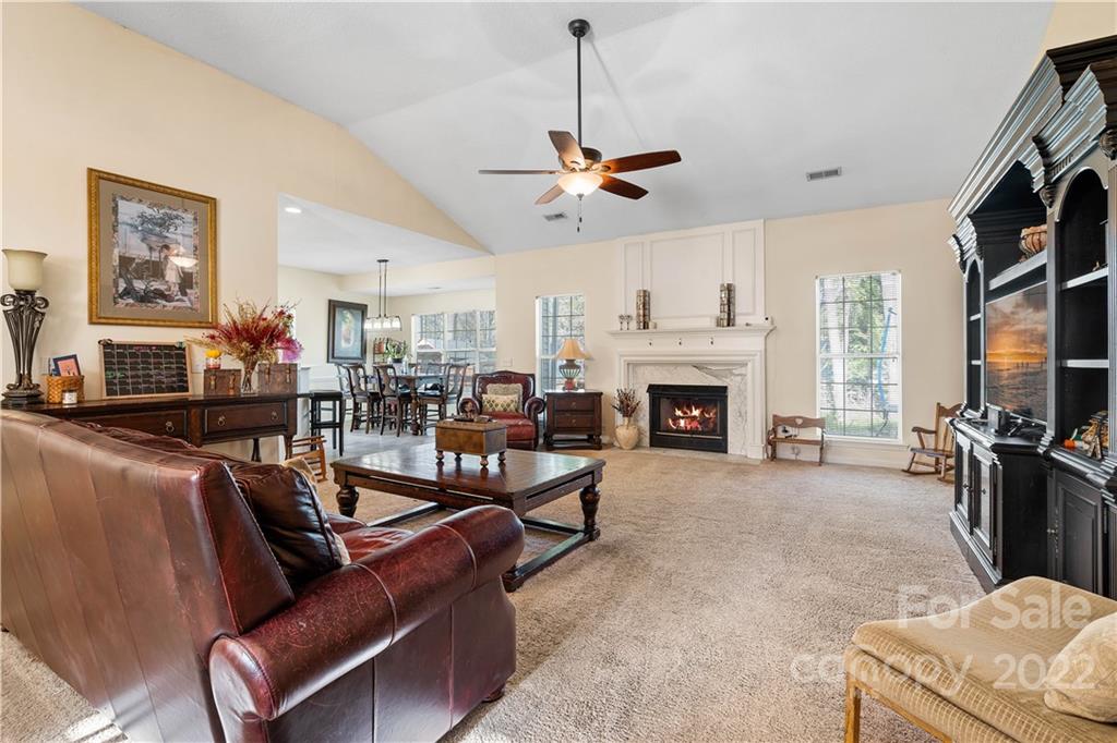 7001 Reedy Creek Road Charlotte, NC 28215 - Photo 5 of 24 a living room with furniture a flat screen tv and a fireplace