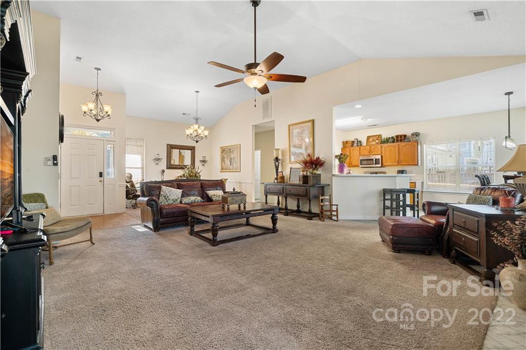 7001 Reedy Creek Road Charlotte, NC 28215 - Photo 6 of 24 a living room with furniture and a chandelier