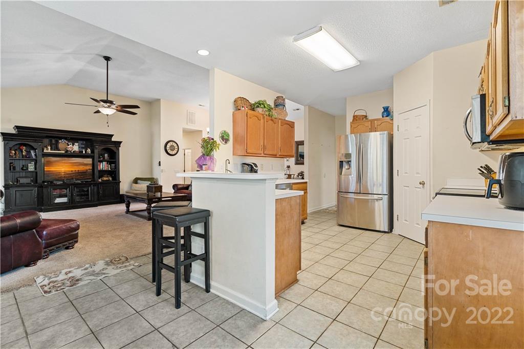 7001 Reedy Creek Road Charlotte, NC 28215 - Photo 10 of 24 a kitchen with stainless steel appliances granite countertop a refrigerator and a stove top oven