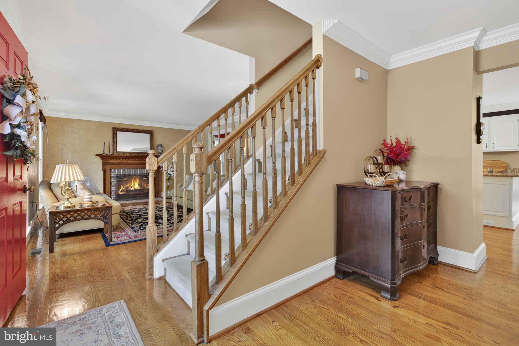 7255 Auburn Mill Road Warrenton, VA 20187 - Photo 12 of 58 a view of a livingroom with furniture stairs wooden floor and windows