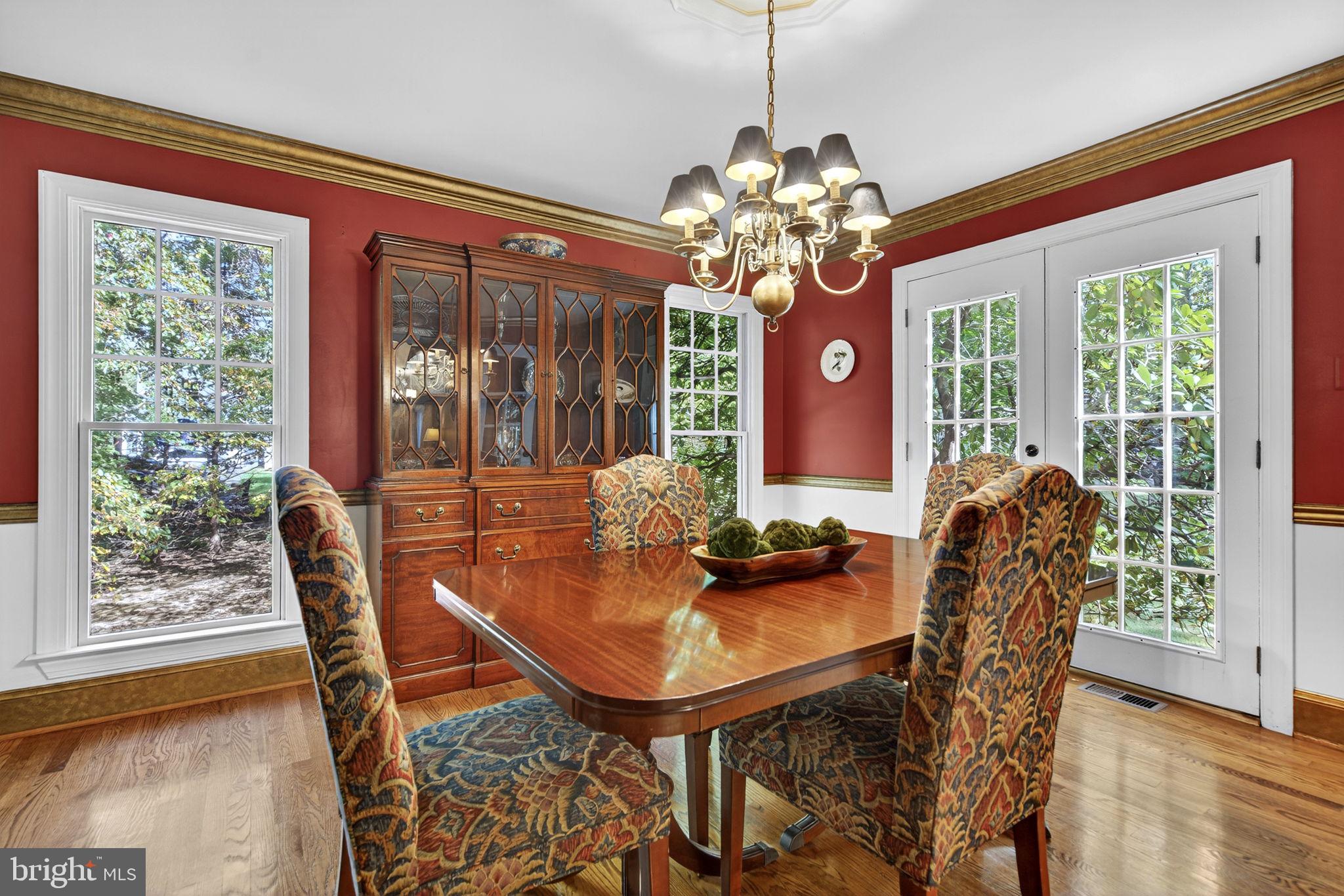 7255 Auburn Mill Road Warrenton, VA 20187 - Photo 19 of 58 a dining room with furniture a chandelier and wooden floor