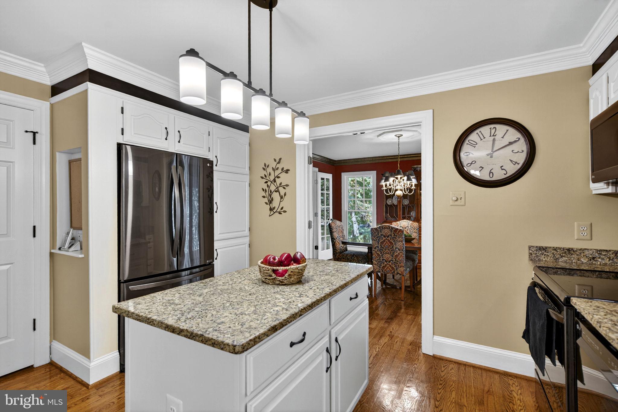 7255 Auburn Mill Road Warrenton, VA 20187 - Photo 22 of 58 a kitchen with a sink and a clock on the wall