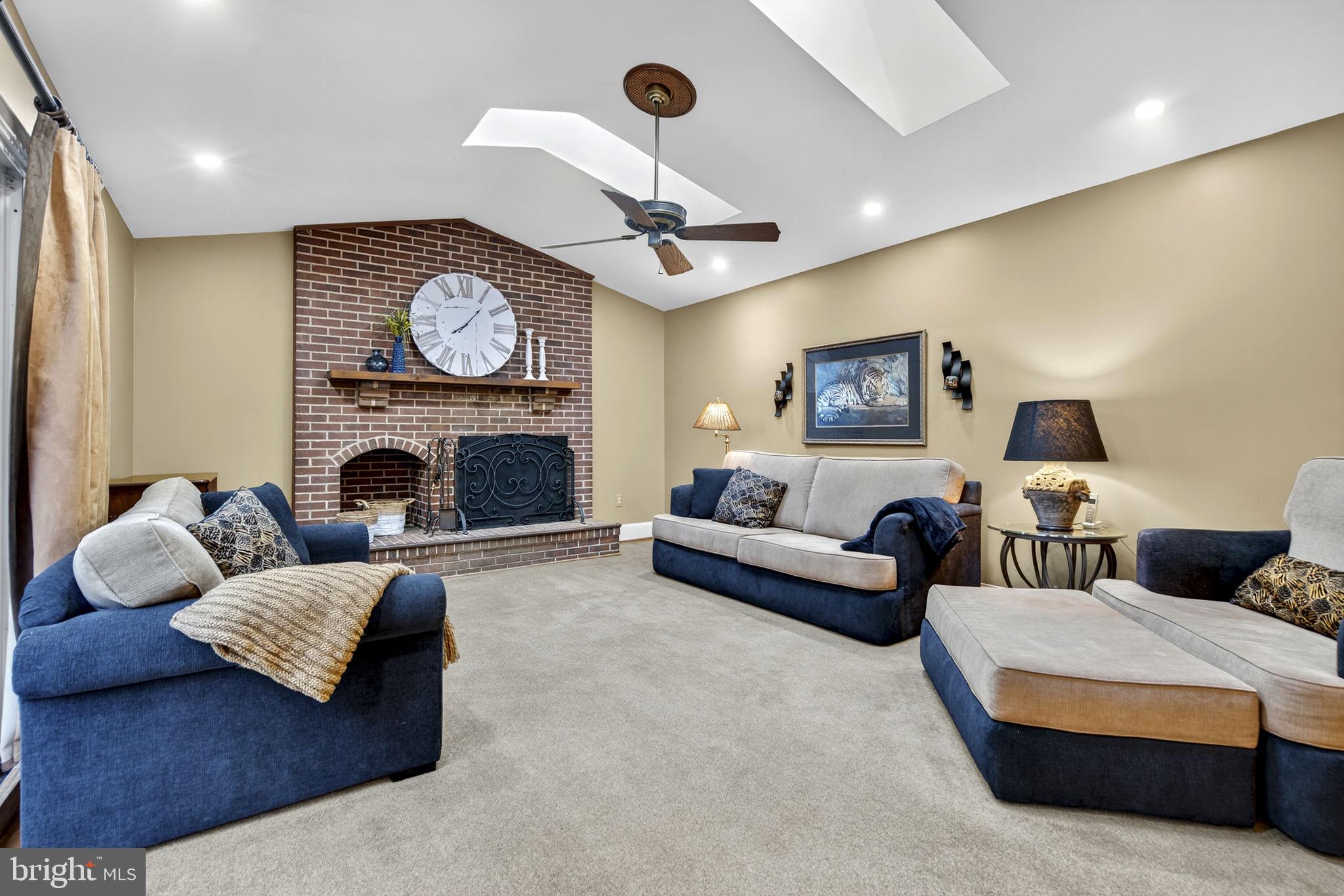 7255 Auburn Mill Road Warrenton, VA 20187 - Photo 28 of 58 a living room with furniture a fireplace and a large mirror