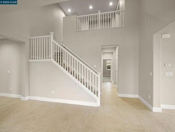 a view of staircase with white walls and stairs