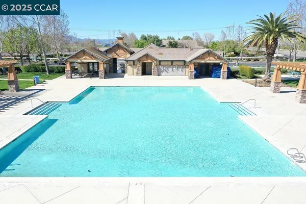 a balcony with a view of the house and swimming pool