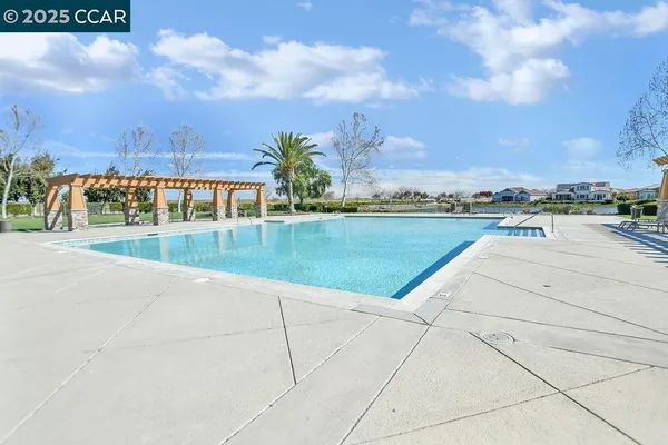 a view of a swimming pool and an outdoor seating