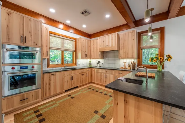 a kitchen with stainless steel appliances granite countertop a refrigerator and a sink