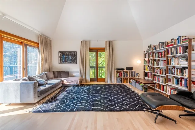 a bedroom with a bed and large window