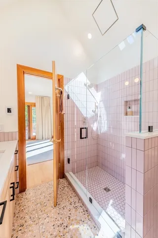a view of a hallway with wooden floor and stairs