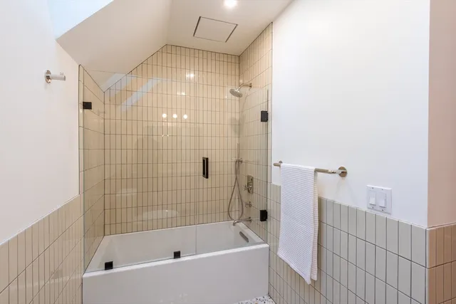 a view of a hallway with wooden floor and stairs