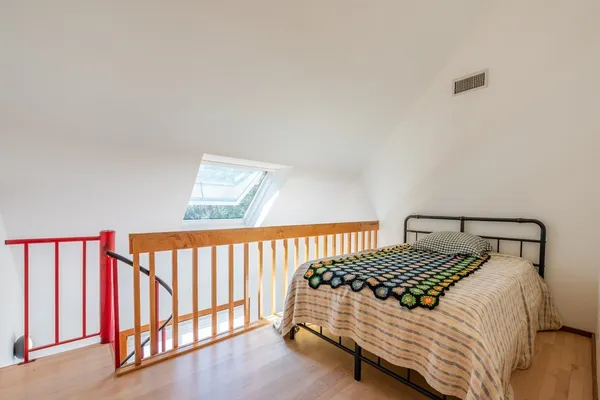 a bedroom with a bed and a book shelf