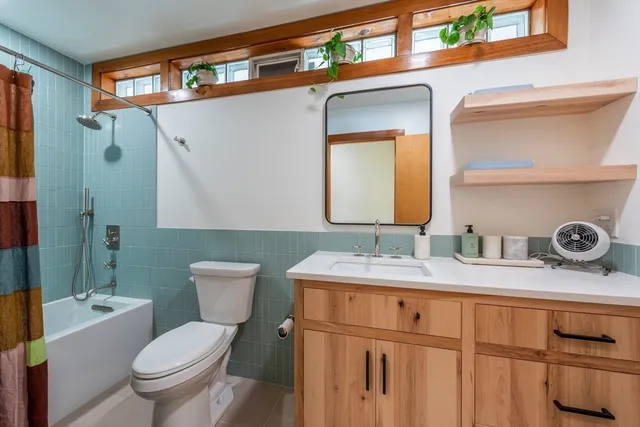 a view of a roof deck with couches under an umbrella