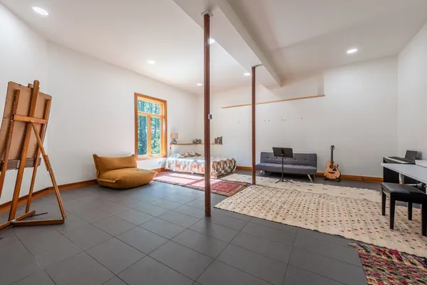 a reading room with furniture and a rug