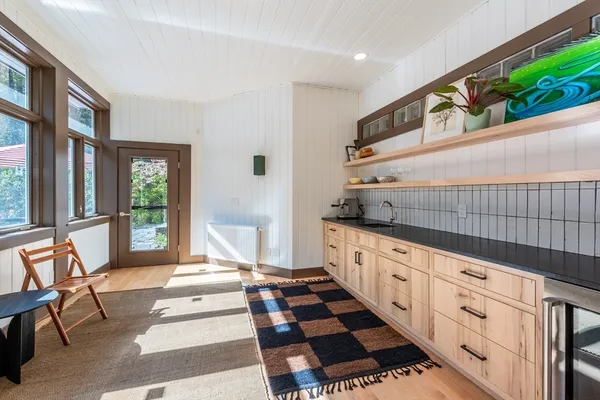 a room with lots of white furniture and window