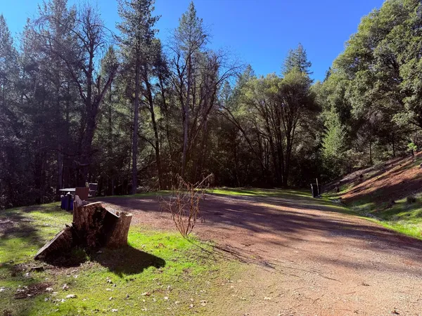 a view of a backyard with swimming pool