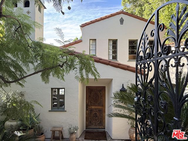 a view of a house with a tree
