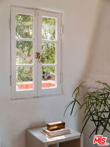 a view of a dining room with furniture and a window