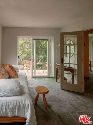 an aerial view of a backyard with chairs and a table