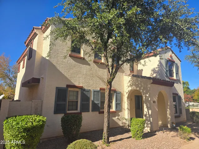 a view of a house with a large tree