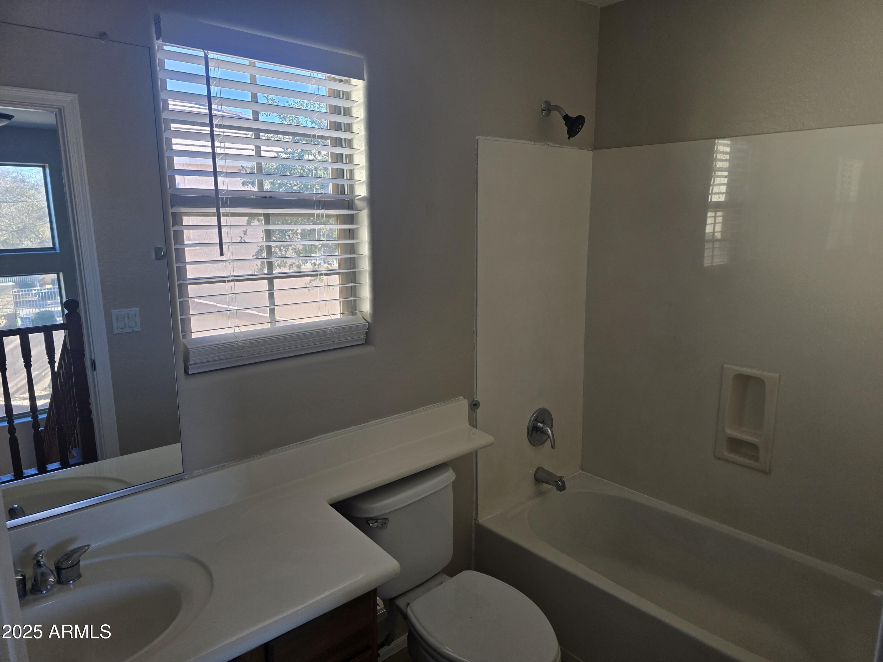 2644 East Megan Street Gilbert, AZ 85295 - Photo 11 of 21 a bathroom with a toilet a sink and a bathtub